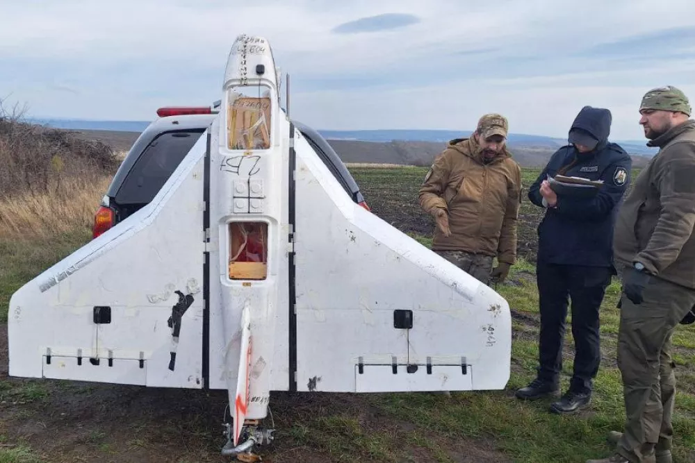This image released by Moldova's Police on Tuesday, Nov. 25, 2025, police officers inspect a drone in the village of Cuhurestii de Jos, northern Moldova. (Moldova Police via AP)