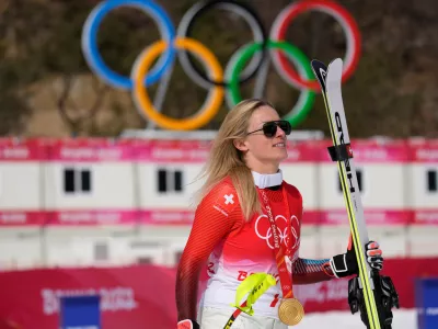 FILE -Lara Gut-Behrami, of Switzerland leaves after the medal ceremony after winning the gold medal in the women's super-G at the 2022 Winter Olympics, Feb. 11, 2022, in the Yanqing district of Beijing. (AP Photo/Luca Bruno, File)
