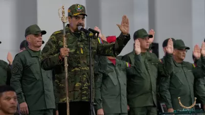 Venezuelan President Nicolas Maduro administers an oath during a civic-military event at the military academy in Caracas, Venezuela, Tuesday, Nov. 25, 2025. (AP Photo/Ariana Cubillos)