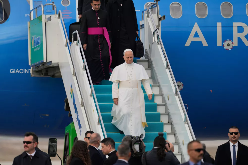 Pope Leo XIV disembarks upon his arrival at Esenboga International Airport in Ankara, Turkey, Thursday, Nov. 27, 2025, marking the beginning of his first foreign trip. (AP Photo/Khalil Hamra)