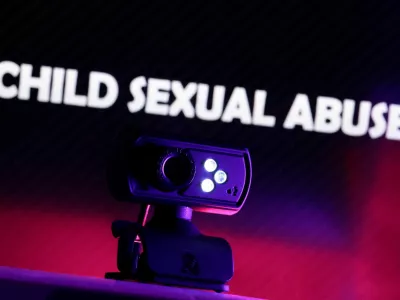 FILE PHOTO: A web camera is seen in front of the displayed words "Child Sexual Abuse" in this illustration taken October 21, 2025. REUTERS/Dado Ruvic/Illustration/File Photo
