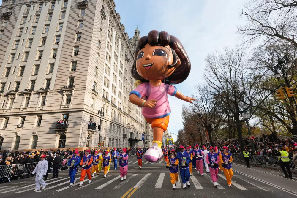 Balloon handlers guide the Dora balloon down Central Park West during the Macy's Thanksgiving Day Parade, Thursday, Nov. 27, 2025, in New York. (AP Photo/Frank Franklin II)