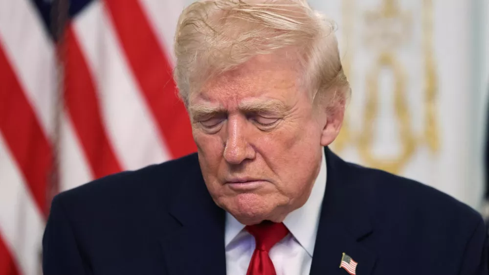 U.S. President Donald Trump looks down as he participates in a call with service members of U.S. Army, JTF-Southern Border, 101st Airborne Division (Fort Huachuca, AZ), U.S. Marine Corps, Battalion Landing Team 3d Battalion 6th Marines (Puerto Rico), U.S. Navy, IWO JIMA ARG, 22 MEU, (Underway, SOUTHCOM AOR), U.S. Air Force, 7th Bomb Wing (Dyess AFB, Abilene, TX), U.S. Space Force, 18th Space Defense Squadron (Vandenberg Space Force Base, CA), and U.S. Coast Guard, USCGC FORREST REDNOUR, WPC-1129 (Underway), on Thanksgiving, in Palm Beach, Florida, U.S., November 27, 2025. REUTERS/Anna Rose Layden