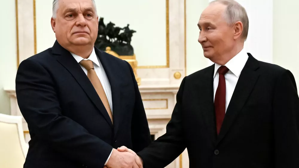 Russian President Vladimir Putin, right, and Hungarian Prime Minister Viktor Orban shake hands during their meeting at the Senate Palace of the Kremlin in Moscow, Russia, Friday, Nov. 28, 2025. (Alexander Nemenov/Pool Photo via AP)