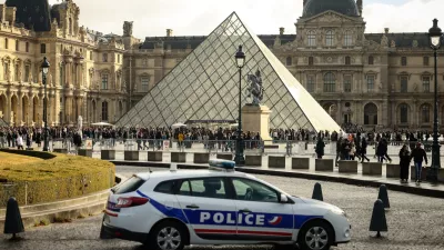 FILE - A police car parks in the courtyard of the Louvre museum, one week after the robbery, on Oct. 26, 2025, in Paris. (AP Photo/Thomas Padilla, File)