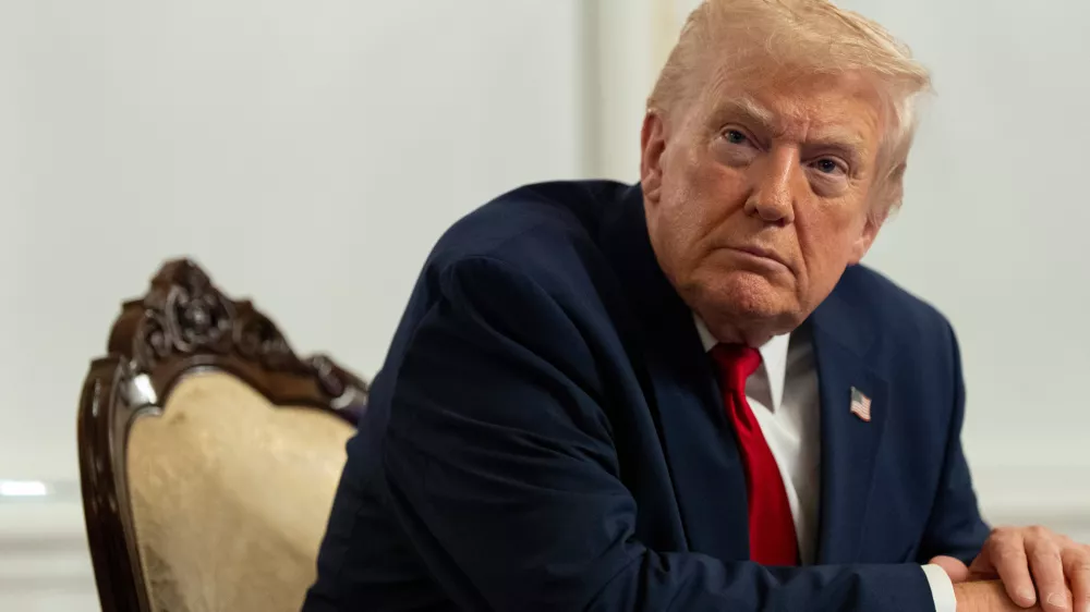 President Donald Trump speaks to reporters after speaking to troops via video from his Mar-a-Lago estate on Thanksgiving, Thursday, Nov. 27, 2025, in Palm Beach, Fla. (AP Photo/Alex Brandon)