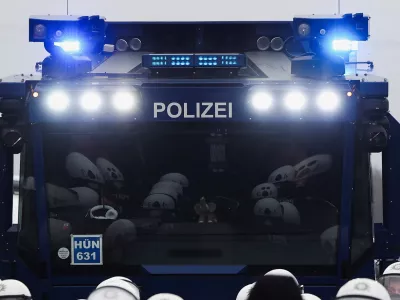 Members of the police are reflected in the windshield of a police vehicle during a protest organized by the Widersetzen (Resist) alliance to block the founding of a new youth organization of Germany's far-right Alternative for Germany (AfD) party, in Giessen, Germany, November 29, 2025. REUTERS/Christian Mang