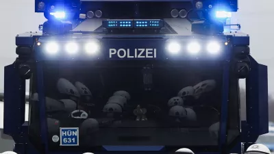 Members of the police are reflected in the windshield of a police vehicle during a protest organized by the Widersetzen (Resist) alliance to block the founding of a new youth organization of Germany's far-right Alternative for Germany (AfD) party, in Giessen, Germany, November 29, 2025. REUTERS/Christian Mang
