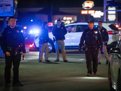 First responders walk through a parking lot near the scene of a mass shooting Saturday, Nov. 29, 2025, in Stockton, Calif. (AP Photo/Ethan Swope)