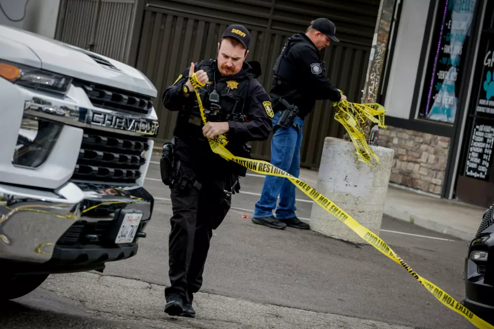 Investigators with the San Joaquin Sheriff's Department remove crime scene tape at Thornton Blvd. and Lucile Ave., where a mass shooting took place Saturday in a banquet hall in Stockton, Calif., Sunday, Nov. 30, 2025. (Bront&euml; Wittpenn/San Francisco Chronicle via AP)