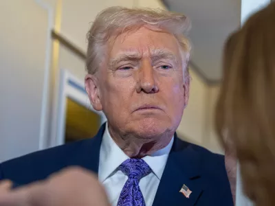 President Donald Trump speaks with reporters while in flight on Air Force One from his Mar-a-Lago estate in Palm Beach, Fla., to Joint Base Andrews, Sunday, Nov. 30, 2025. (AP Photo/Alex Brandon)