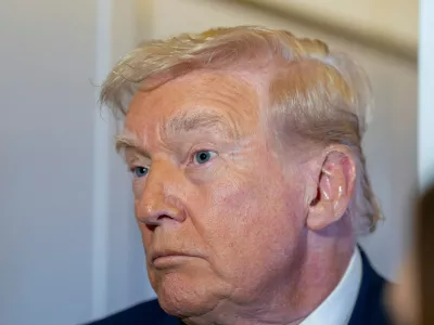 President Donald Trump speaks with reporters while in flight on Air Force One from his Mar-a-Lago estate in Palm Beach, Fla., to Joint Base Andrews, Sunday, Nov. 30, 2025. (AP Photo/Alex Brandon)