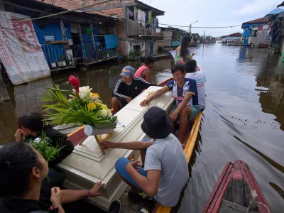 Friends and relatives of Jorge Luis Mendoza Cuelho, 14, ride with his coffin during his funeral in Belen, a district nicknamed the "Venice of the Jungle," in Iquitos, Peru, on May 23, 2025. (AP Photo/Rodrigo Abd, File)