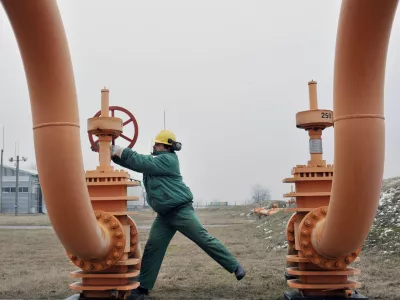 An engineer of the FGSZ Ltd, Hungary's natural gas transporting company turns a gas pipeline valve forwarding natural gas from underground storage facilities for the country's capital at a gas receiving station in Vecses (27 km/16 miles east of Budapest), Hungary, Wednesday, Jan. 14, 2009. However Russia opened the flow of natural gas to Ukraine on Tuesday, Ukraine's gas company Naftogaz did not deliver the gas to Europe, saying Russia's Gazprom demanded it use a route that was technically arduous and would force it to halt supplies to a large swath of its own territory. The politically charged gas dispute has dramatically lowered supplies to Europe and angered the European Union. (AP Photo/Bela Szandelszky)