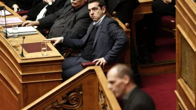 Greek Prime Minister Alexis Tsipras (C) listens to the speech of Greek Finance Minister Yanis Varoufakis (bottom) before a vote of confidence at the parliament in Athens February 10, 2015. Athens is not seeking a clash with its European partners but cannot exclude one, Varoufakis told parliament on the eve of a crucial euro zone finance ministers' meeting to discuss the country's future. REUTERS/Alkis Konstantinidis (GREECE - Tags: POLITICS BUSINESS)