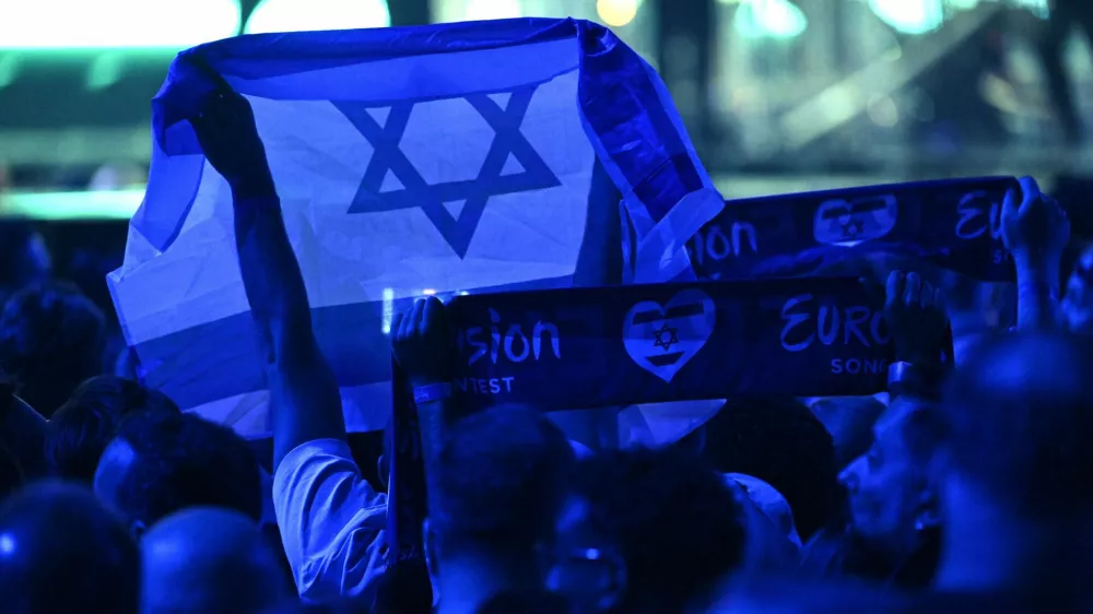 17 May 2025, Switzerland, Basel: A person holds an Israeli flag during the Grand Final of the Eurovision Song Contest 2025 in Basel. The European Broadcasting Union (EBU), which organizes Eurovision, said on Thursday that it will hold an online meeting in November to vote on participation in the 2026 contest, as debate over Israel's involvement continues to stir controversy. Photo: Heikki Saukkomaa/Lehtikuva/dpa