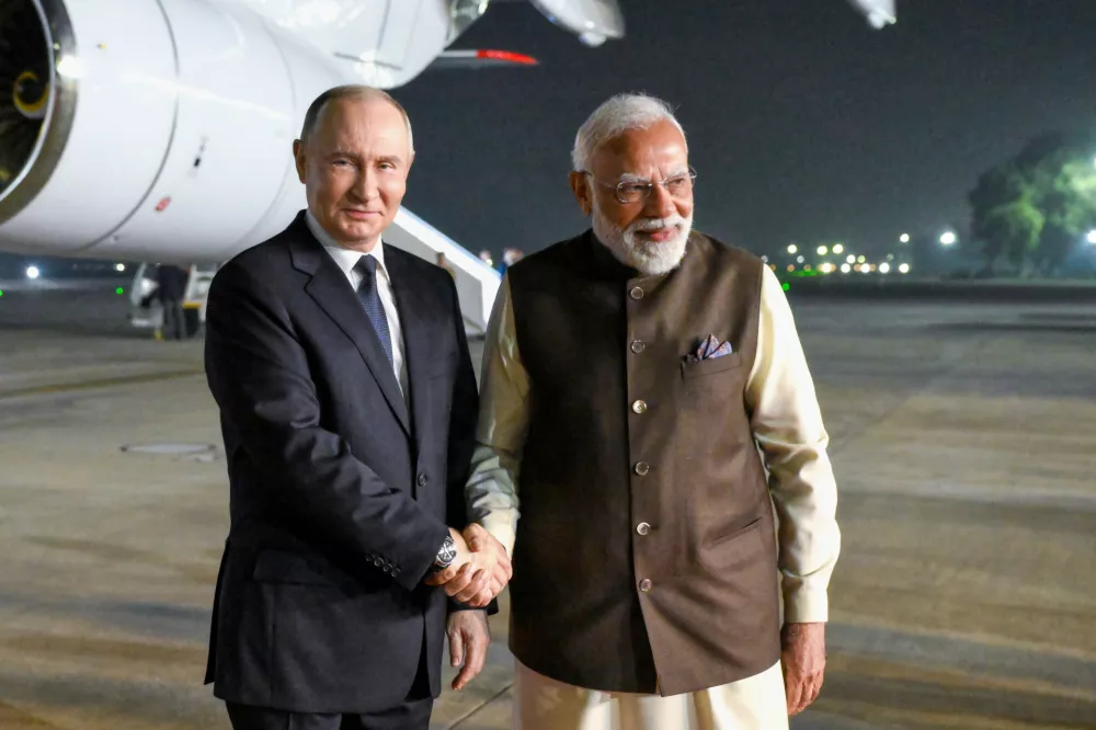 Russian President Vladimir Putin, left, and Indian Prime Minister Narendra Modi pose for a photo at the Palam Air Base in New Delhi, India, on Thursday, Dec. 4, 2025. (Grigory Sysoyev, Sputnik, Kremlin Pool Photo via AP)