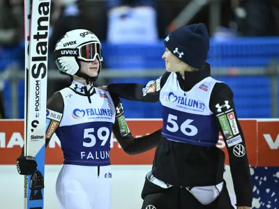 Nika Prevc, of Slovenia, left, and Nika Vodan, of Slovenia, react after completing the women's Individual HS95 FIS World Cup Ski Jumping event in Falun, Sweden, Friday, Nov. 28, 2025. (Fredrik Sandberg/TT News Agency via AP)