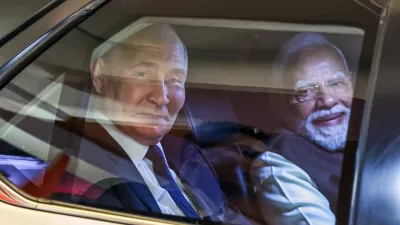 Russian President Vladimir Putin, left, and Indian Prime Minister Narendra Modi sit inside a limousine as they arrive at the Indian Prime Minister office in New Delhi, India, on Thursday, Dec. 4, 2025. (Alexander Kazakov, Sputnik, Kremlin Pool Photo via AP)