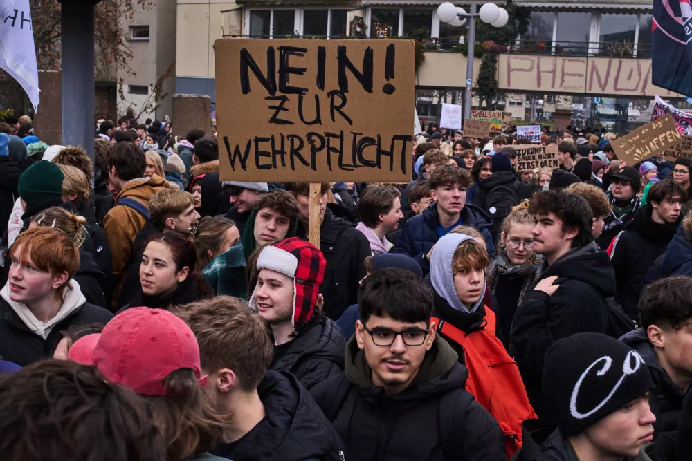 Students show a poster reading: "No to mandatory military service", during a protest against the planned possibility of a compulsory military service in Berlin, Germany, Friday, Dec. 5, 2025. (AP Photo/Markus Schreiber)
