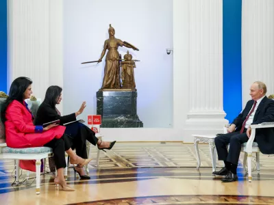 Russian President Vladimir Putin, right, speaks during an interview with journalists and executives of Aaj Tak and India Today TV channels at the Kremlin in Moscow, Russia, Wednesday, Dec. 3, 2025. (Vyacheslav Prokofyev/Sputnik, Kremlin Pool Photo via AP)