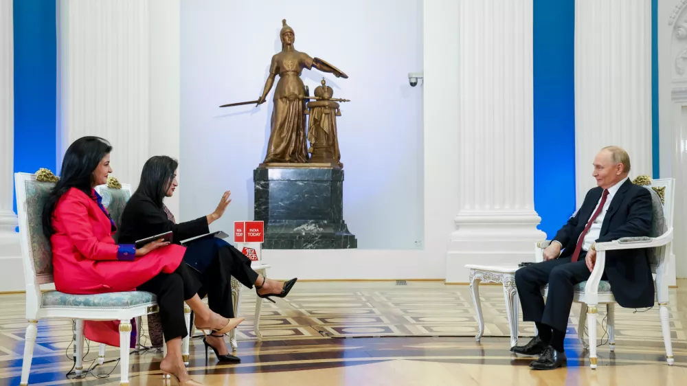 Russian President Vladimir Putin, right, speaks during an interview with journalists and executives of Aaj Tak and India Today TV channels at the Kremlin in Moscow, Russia, Wednesday, Dec. 3, 2025. (Vyacheslav Prokofyev/Sputnik, Kremlin Pool Photo via AP)