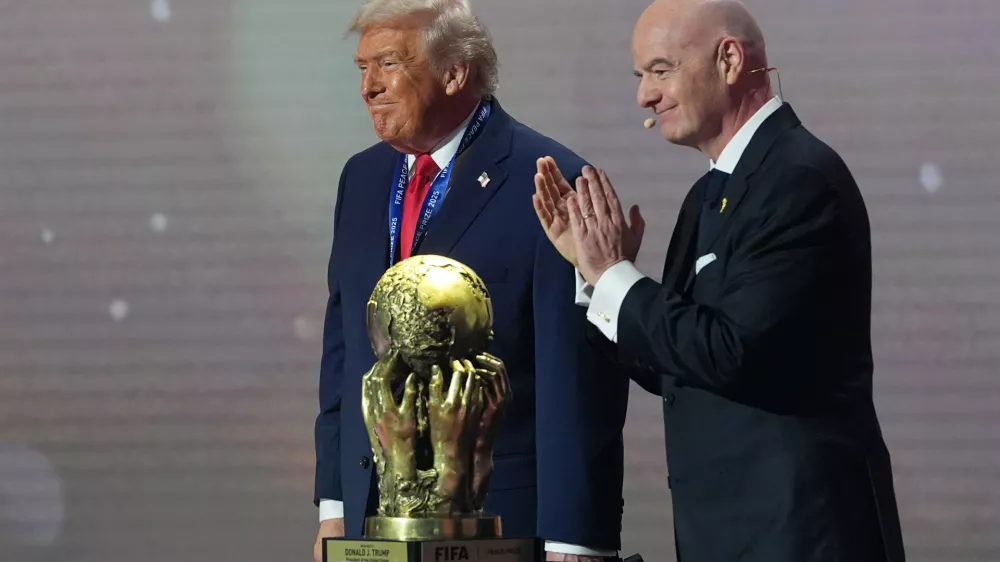 President Donald Trump receives the FIFA Peace Prize from FIFA President Gianni Infantino during the draw for the 2026 soccer World Cup at the Kennedy Center in Washington, Friday, Dec. 5, 2025. (AP Photo/Jacquelyn Martin)