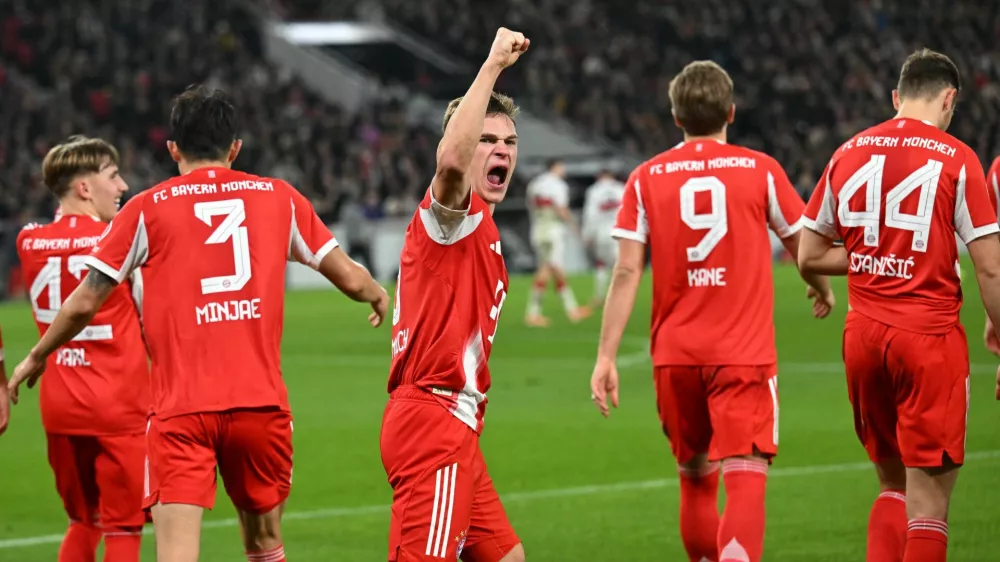 Soccer Football - Bundesliga - VfB Stuttgart v Bayern Munich - MHPArena, Stuttgart, Germany - December 6, 2025 Bayern Munich's Joshua Kimmich celebrates after Harry Kane scored their fourth goal REUTERS/Angelika Warmuth DFL REGULATIONS PROHIBIT ANY USE OF PHOTOGRAPHS AS IMAGE SEQUENCES AND/OR QUASI-VIDEO.