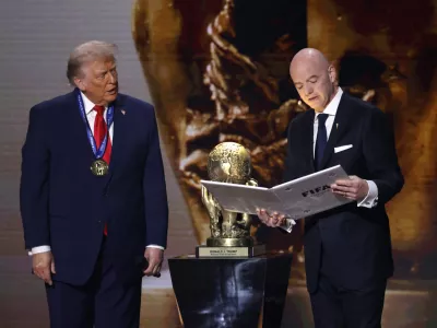 Dec 5, 2025; Washington, District of Columbia, USA; FIFA president Gianni Infantino presents United States President Donald Trump with the FIFA Peace Prize during the FIFA World Cup 2026 Final Draw at John F. Kennedy Center for the Performing Arts. Mandatory Credit: Amber Searls-Imagn Images