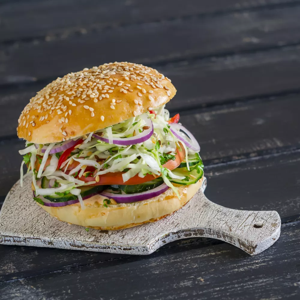 delicious veggie burger on a dark wooden surface. Healthy breakfast or snack