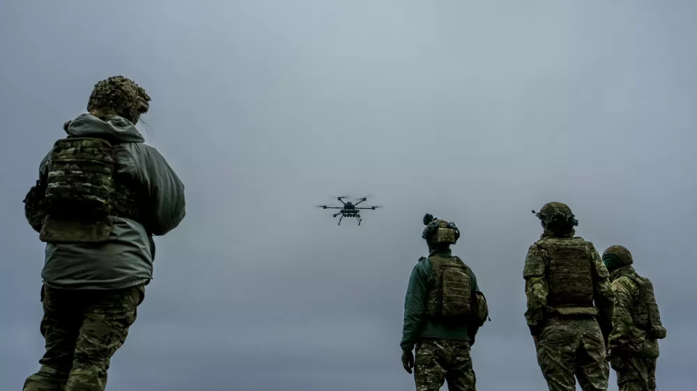 A Ukrainian drone operator from the Kraken 1654 unit, callsign Imla, left, flies a Vampire drone as other soldiers watch, during a demonstration for The Associated Press, Wednesday, Nov. 5, 2025, in Kharkiv Oblast, Ukraine. (AP Photo/Julia Demaree Nikhinson)