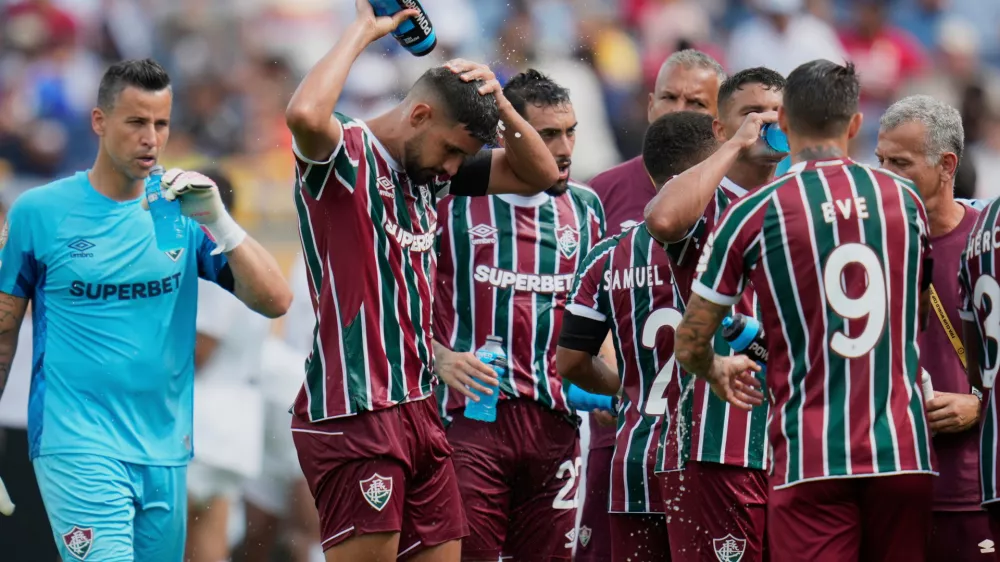 FILE - Fluminense players cooling up during a water break at the Club World Cup quarterfinal soccer match between Fluminense and Al Hilal in Orlando, Fla., Friday, July 4, 2025. (AP Photo/John Raoux, file)