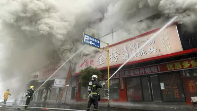 Firemen put out a fire at a building in Wenzhou, Zhejiang province, December 12, 2007. The fire in a ground-floor flower shop in east China spread into a block of apartments above on Wednesday, killing at least 19 people, media said. REUTERS/China Daily (CHINA) CHINA OUT