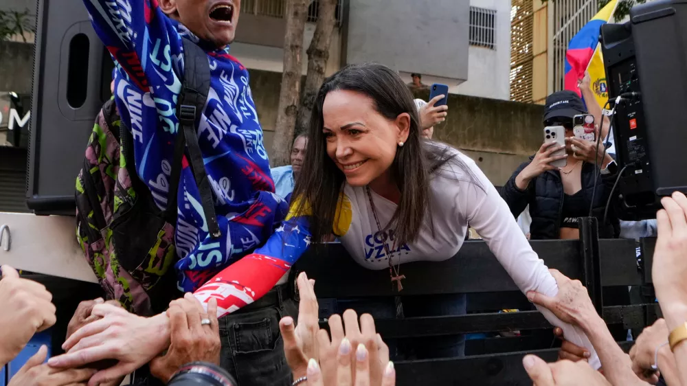 FILE - Opposition leader Maria Corina Machado greets supporters during a protest against Venezuelan President Nicolas Maduro the day before his inauguration for a third term in Caracas, Venezuela, Thursday, Jan. 9, 2025. (AP Photo/Matias Delacroix, file)