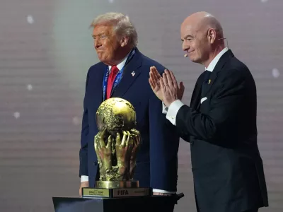 President Donald Trump receives the FIFA Peace Prize from FIFA President Gianni Infantino during the draw for the 2026 soccer World Cup at the Kennedy Center in Washington, Friday, Dec. 5, 2025. (AP Photo/Jacquelyn Martin)