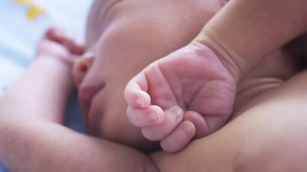 High Angle View Of Baby Sleeping On Bed At Home