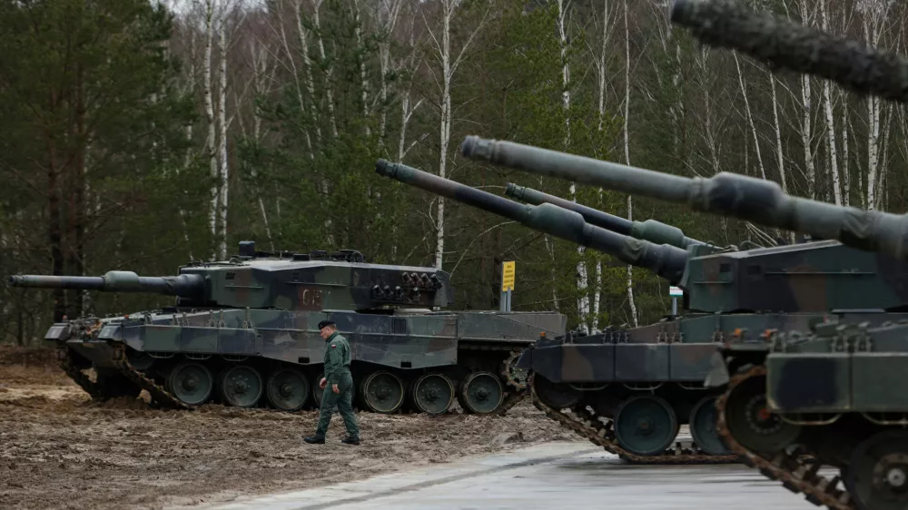 FILE - A Polish soldier walks next to the Leopard 2 tanks during a training at a military base and test range in Swietoszow, Poland, Monday, Feb. 13, 2023. (AP Photo/Michal Dyjuk, File)