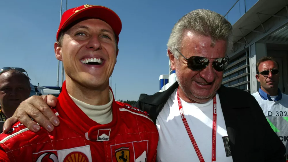 German Formula One World Champion Michael Schumacher (L) is hugged byhis manager Willi Weber after his German Grand Prix victory at theHockenheim race track July 28, 2002. Schumacher returned home in styleon Sunday, adding a rare and record-equalling German Grand Prix win tohis historic fifth Formula One title. REUTERS/Ralph OrlowskiMAD/GB