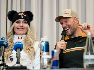Coach and former Norwegian skier Aksel Lund Svindal, right, speaks with Lindsey Vonn, of the United States, during a press conference ahead of the women's World Cup downhill race Wednesday, Dec. 10, 2025 at the hotel Kempinski in St. Moritz, Switzerland. (Claudio Thoma/Keystone via AP)