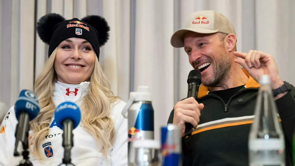 Coach and former Norwegian skier Aksel Lund Svindal, right, speaks with Lindsey Vonn, of the United States, during a press conference ahead of the women's World Cup downhill race Wednesday, Dec. 10, 2025 at the hotel Kempinski in St. Moritz, Switzerland. (Claudio Thoma/Keystone via AP)