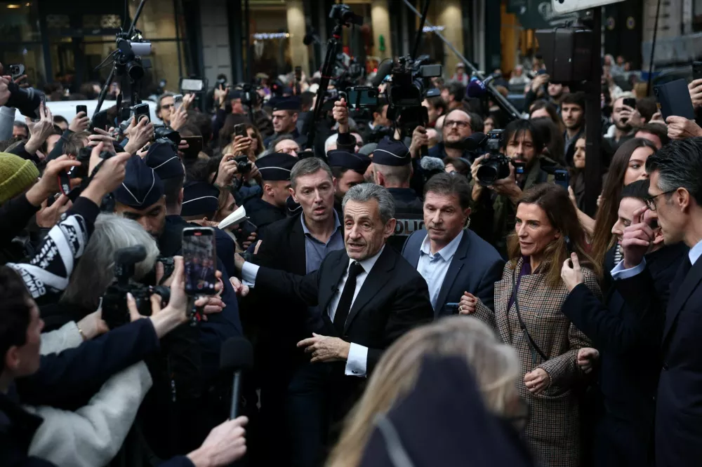 Former French President Nicolas Sarkozy arrives at a bookstore to sign copies of his memoir "Journal of a Prisoner," which recounts his time in prison after being jailed for criminal conspiracy, in Paris, France, December 10, 2025. REUTERS/Gonzalo Fuentes