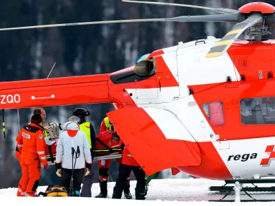 Michelle Gisin of Switzerland is being carried on a stretcher after a fall during an alpine ski, women's World Cup downhill training, in St. Moritz, Switzerland, Thursday, Dec. 11, 2025. (Keystone Via AP)