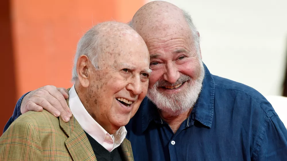 FILE - Carl Reiner, left, and his son Rob Reiner pose together following their hand and footprint ceremony at the TCL Chinese Theatre, April 7, 2017, in Los Angeles. (Photo by Chris Pizzello/Invision/AP, File)