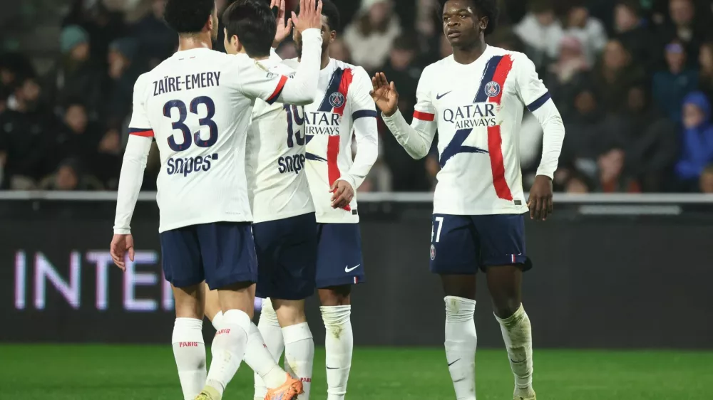 Soccer Football - Ligue 1 - FC Metz v Paris St Germain - Stade Saint-Symphorien, Metz, France - December 13, 2025 Paris St Germain's Quentin Ndjantou celebrates scoring their second goal with teammates REUTERS/Catherine Steenkeste