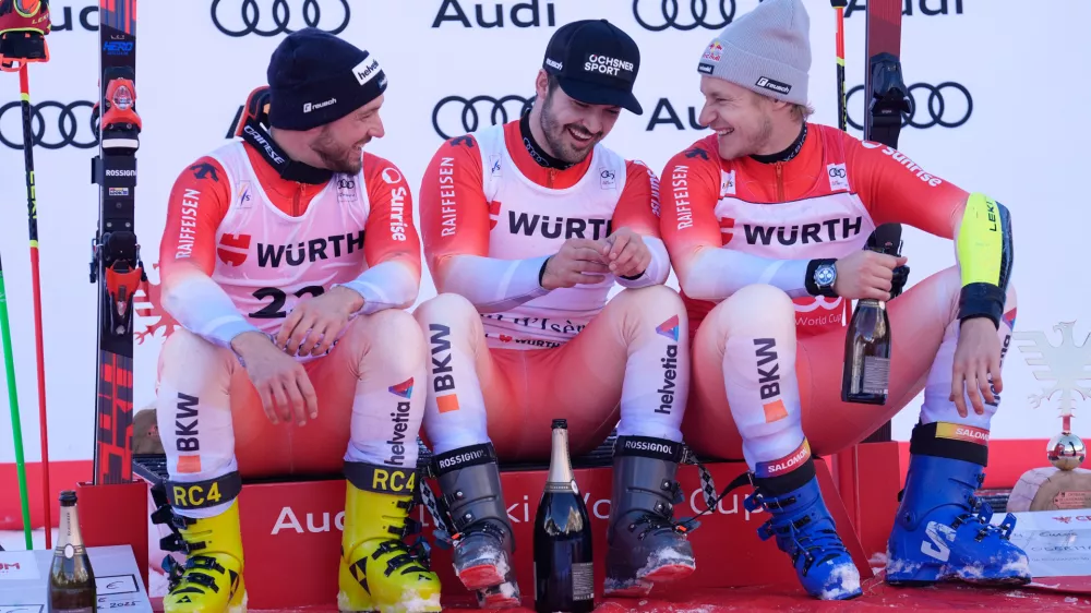 Switzerland's Loic Meillard, center, winner of an alpine ski, men's World Cup giant slalom event, sits by fellow-countrymen second placed Luca Aerni, left, and third placed Marco Odermatt, in Val d'Isere, France, Saturday Dec. 13, 2025. (AP Photo/Giovanni Auletta) (AP Photo/Giovanni Auletta)