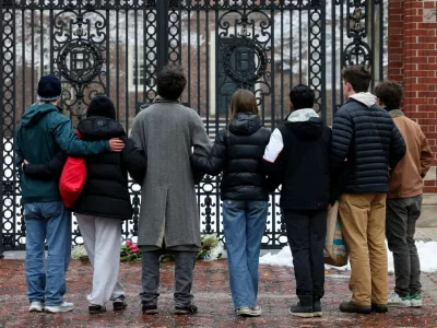 Students stand in front of the Van Wickle Gates after placing flowers, following a shooting at Brown University, in Providence, Rhode Island, U.S. December 14, 2025. REUTERS/Kylie Cooper   TPX IMAGES OF THE DAY