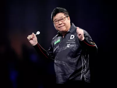 13 December 2025, United Kingdom, London: Singapore's Paul Lim celebrates during his match against Jeffrey de Graaf on day three of the Paddy Power World Darts Championship at the Alexandra Palace. Photo: John Walton/PA Wire/dpa