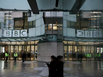FILE PHOTO: People stand outside BBC Broadcasting House, after Director General Tim Davie and CEO of BBC News Deborah Turness resigned on Sunday, November 9, following accusations of bias at the British broadcaster, including in the way it edited a speech by U.S. President Donald Trump, in London, Britain, November 14, 2025. REUTERS/Isabel Infantes/File Photo