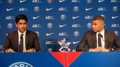 FILE - PSG striker Kylian Mbappe, right, and PSG president Nasser Al-Al-Khelaifi attend a press conference Monday, May 23, 2022 at the Paris des Princes stadium in Paris. (AP Photo/Michel Spingler, File)