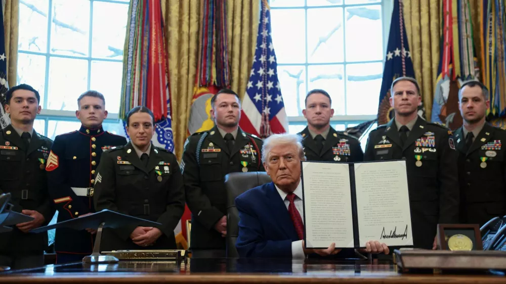 U.S. President Donald Trump shows a signed executive order classifying fentanyl as 'weapon of mass destruction' during a Mexican Border Defense Medal presentation in the Oval Office at the White House in Washington, D.C., U.S., December 15, 2025. REUTERS/Evelyn Hockstein